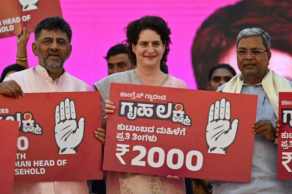 Indian National Congress leaders Priyanka Gandhi (c) with Siddaramaiah (r) and DK Shivakumar (l)