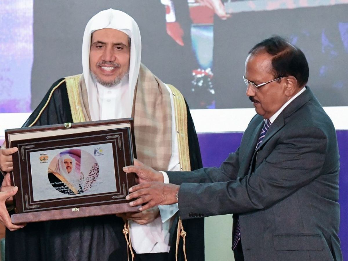 Indian national security adviser Ajit Doval (R) felicitates Saudi Arabia leader and Muslim World League secretary general Sheikh Dr Mohammed bin Abdulkarim Al-Issa