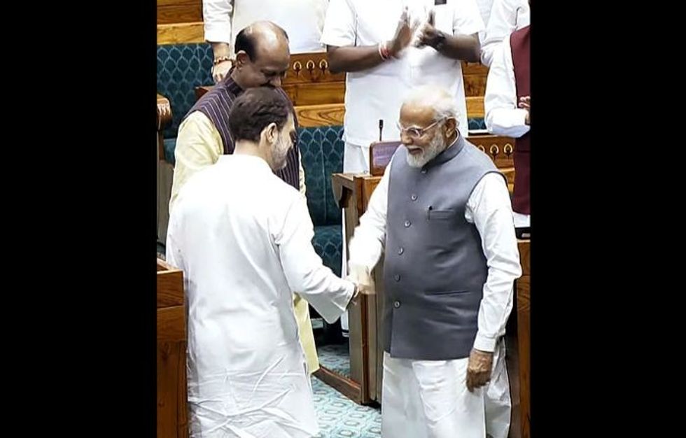 Indian PM Narendra Modi shakes hands with leader of opposition Rahul Gandhi in the Indian parliament in New Delhi on June 26, 2024.