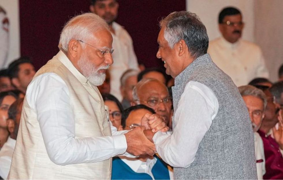 Indian PM Narendra Modi with the son of one of the recipients of Bharat Ratna Award Karpoori Thakur, who took the award on behalf of his late father