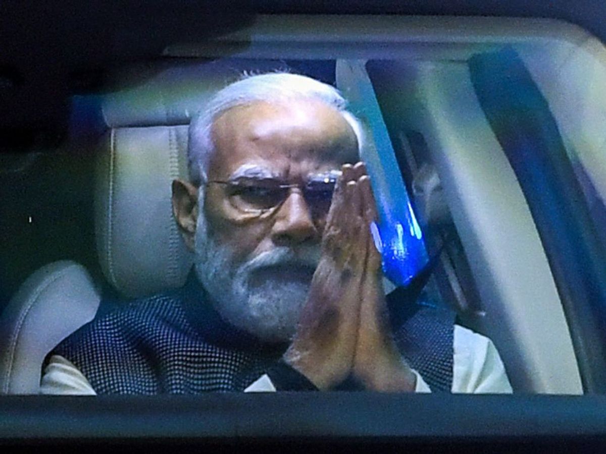 Indian prime minister Narendra Modi greets as he arrives to attend an event organised upon his arrival to India post concluding his three-nation visit to Japan, Papua New Guinea and Australia, in New Delhi