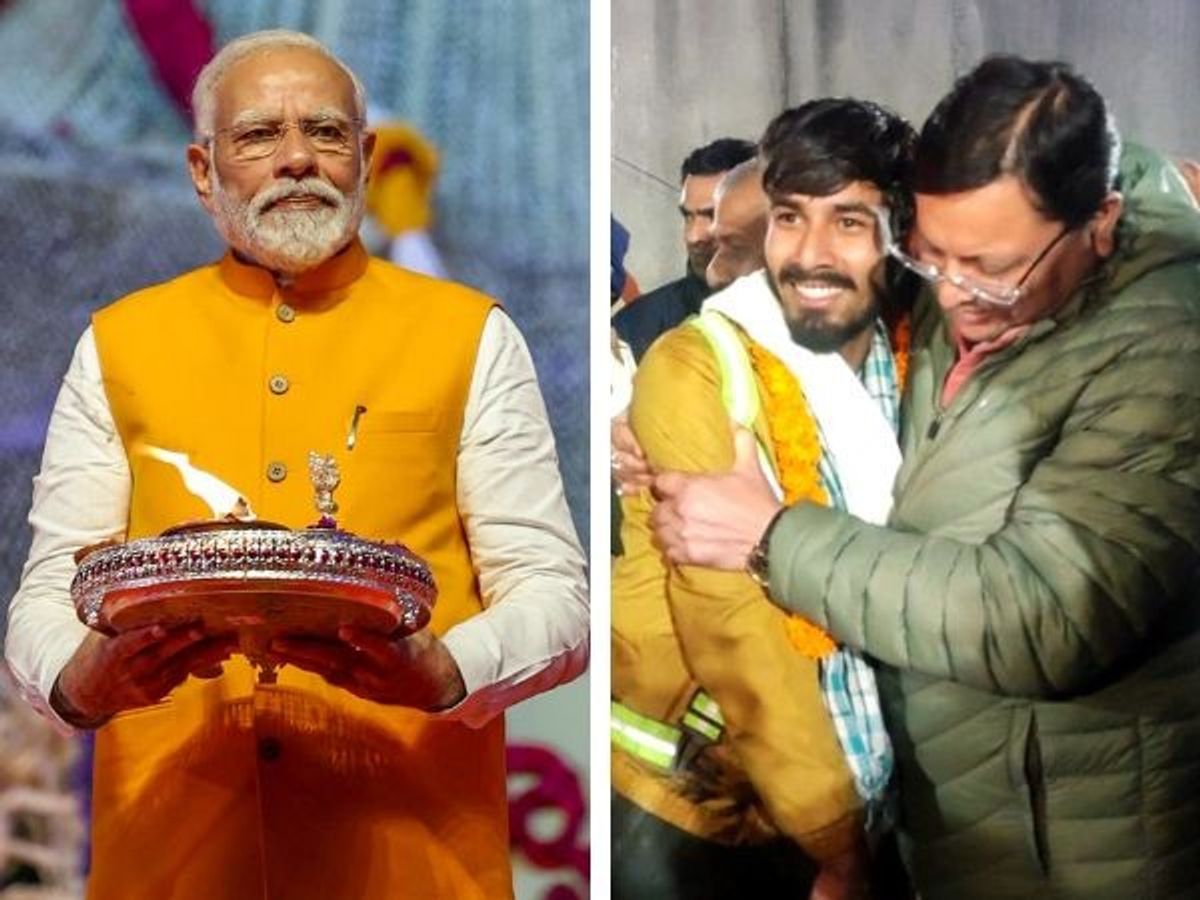 Indian prime minister Narendra Modi (L) and Uttarakhand chief minister Pushkar Singh Dhami embraces one of the 41 workers who were trapped inside the Silkyara tunnel in the state's Uttarkashi after the rescue operation concluded successfully