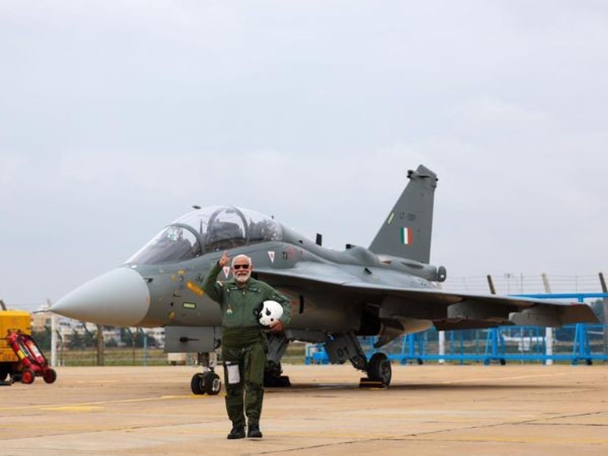 Indian prime minister Narendra Modi poses before India's indigenously built light combat fighter aircraft Tejas in Bengaluru