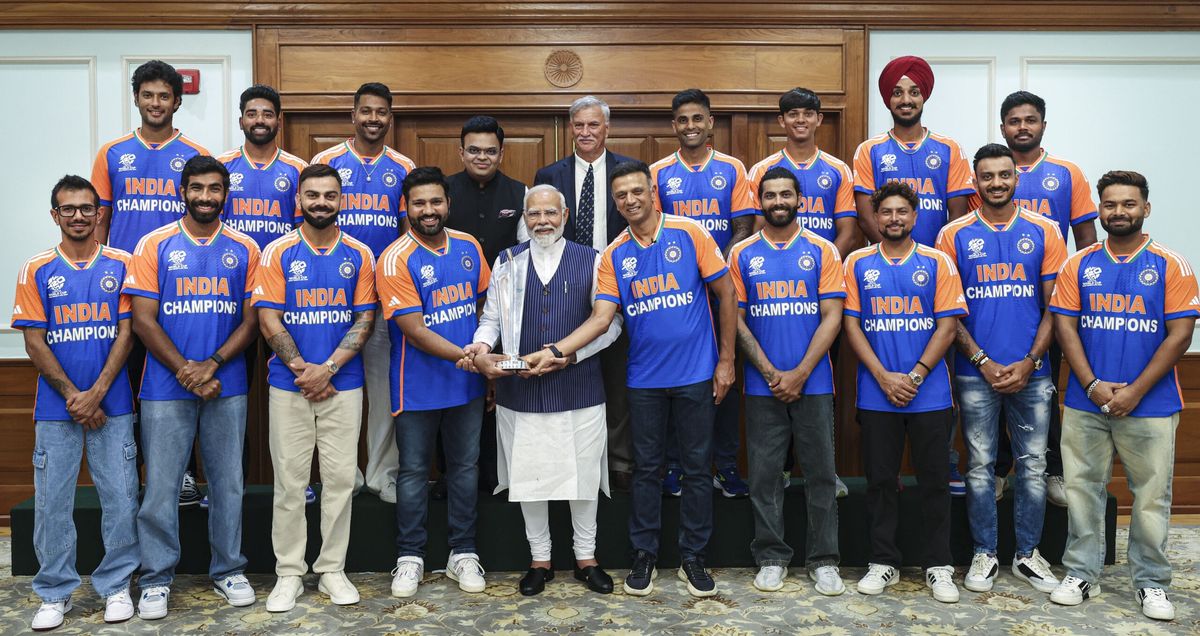 Indian prime minister Narendra Modi poses for group photos with the T20 World Cup-winning Indian cricket team and the championship trophy during a breakfast hosted hosted by him at his official residence in New Delhi