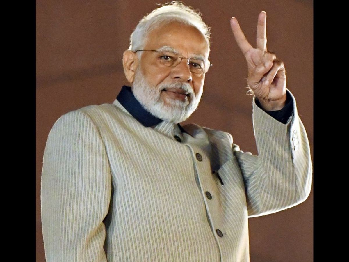 Indian prime minister Narendra Modi shows a victory sign to BJP supporters after the party's emphatic victory in the Gujarat assembly elections