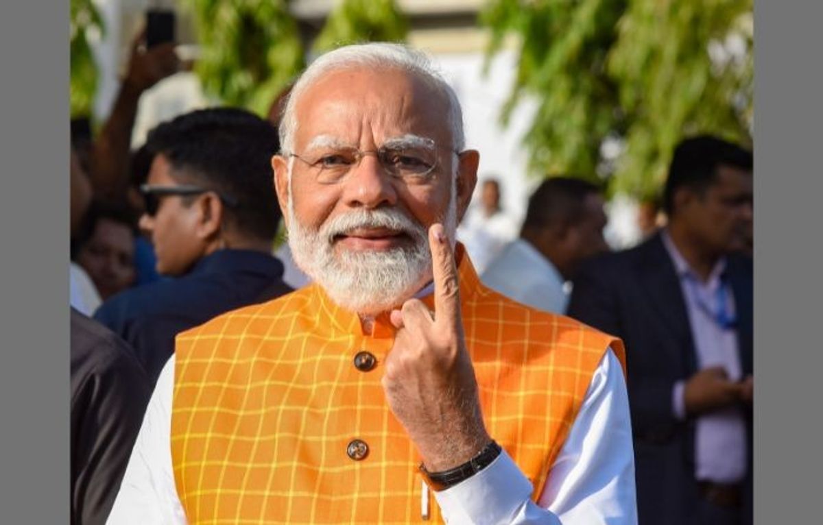 Indian prime minister Narendra Modi shows his ink-marked finger after casting his vote at a polling station during the third phase of Lok Sabha elections, in Ahmedabad in the western state of Gujarat on Tuesday, May 7, 2024.