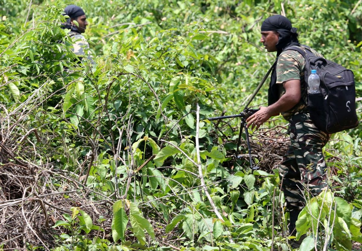 Indian security forces patrol a forest area infested by Maoists