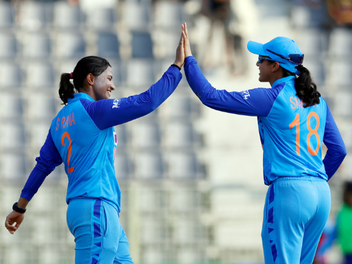 Indian skipper Smriti Mandhana (R) celebrate on the field with Sneh Rana