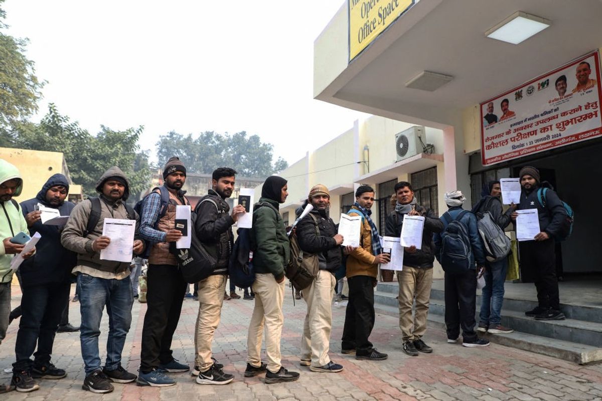 Indian workers stand in a queue to get an opportunity to travel to Israel for work in construction sector