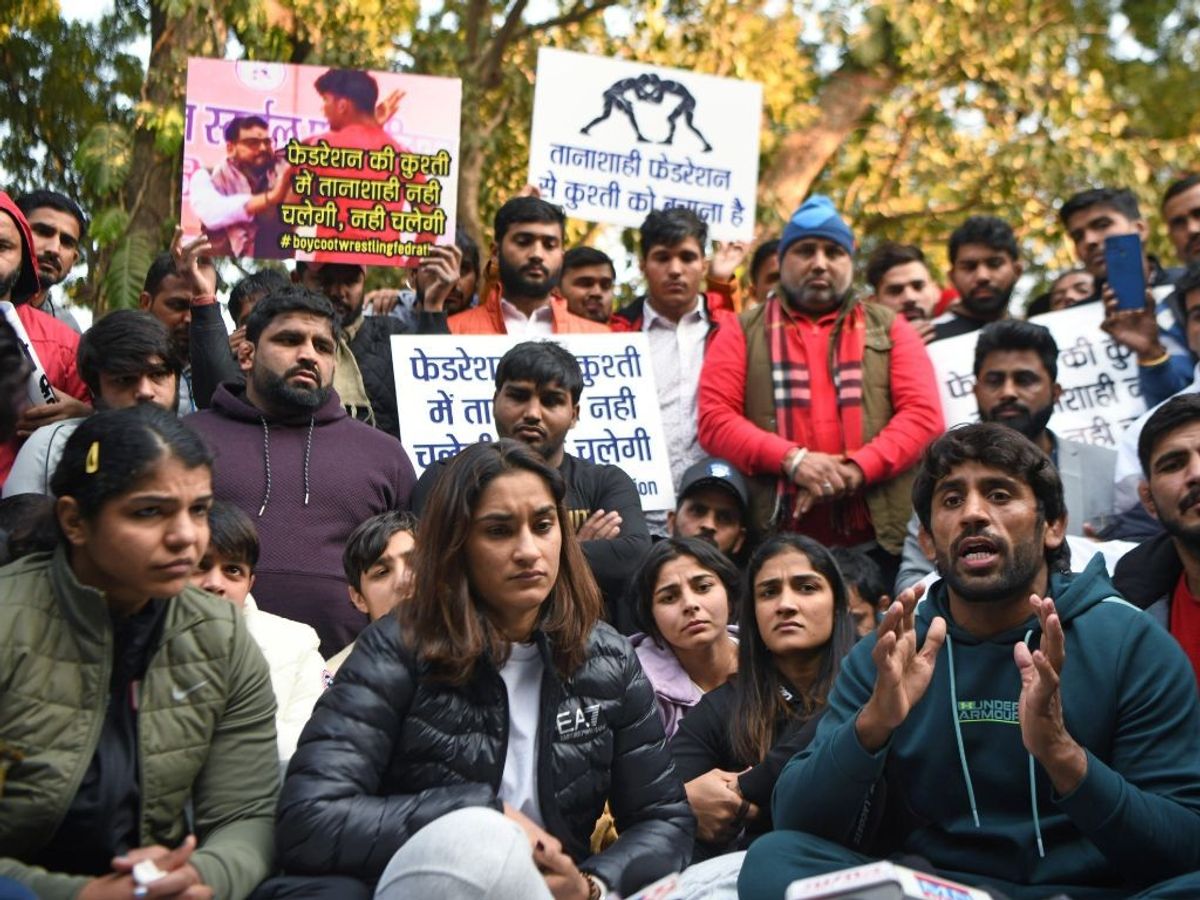Indian wrestler Bajrang Punia (extreme right) speaks to the media during the protest against Wrestling Federation of India over its alleged harassment of wrestlers at Jantar Mantar, in New Delhi on Wednesday, January 18, 2023. Wrestlers Vinesh Phogat (C) and Sakshi Malik are also seen