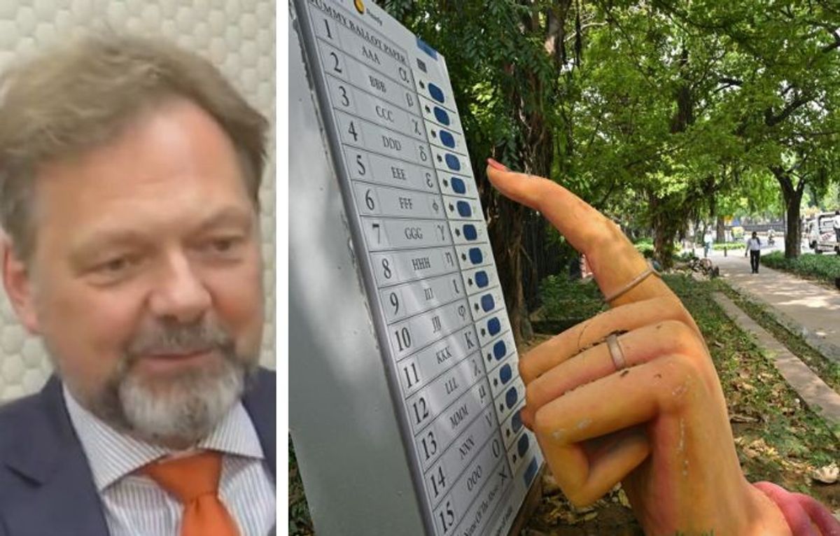 (L-R) German ambassador to India Philipp Ackermann and a model electronic voting machine that will be used for India's upcoming general elections