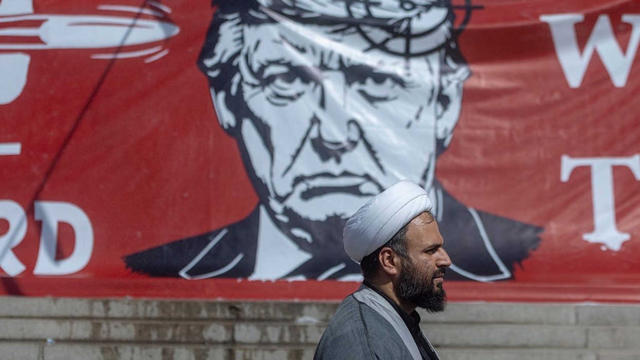 Large banner depicting U.S. President Donald Trump with a target on his head