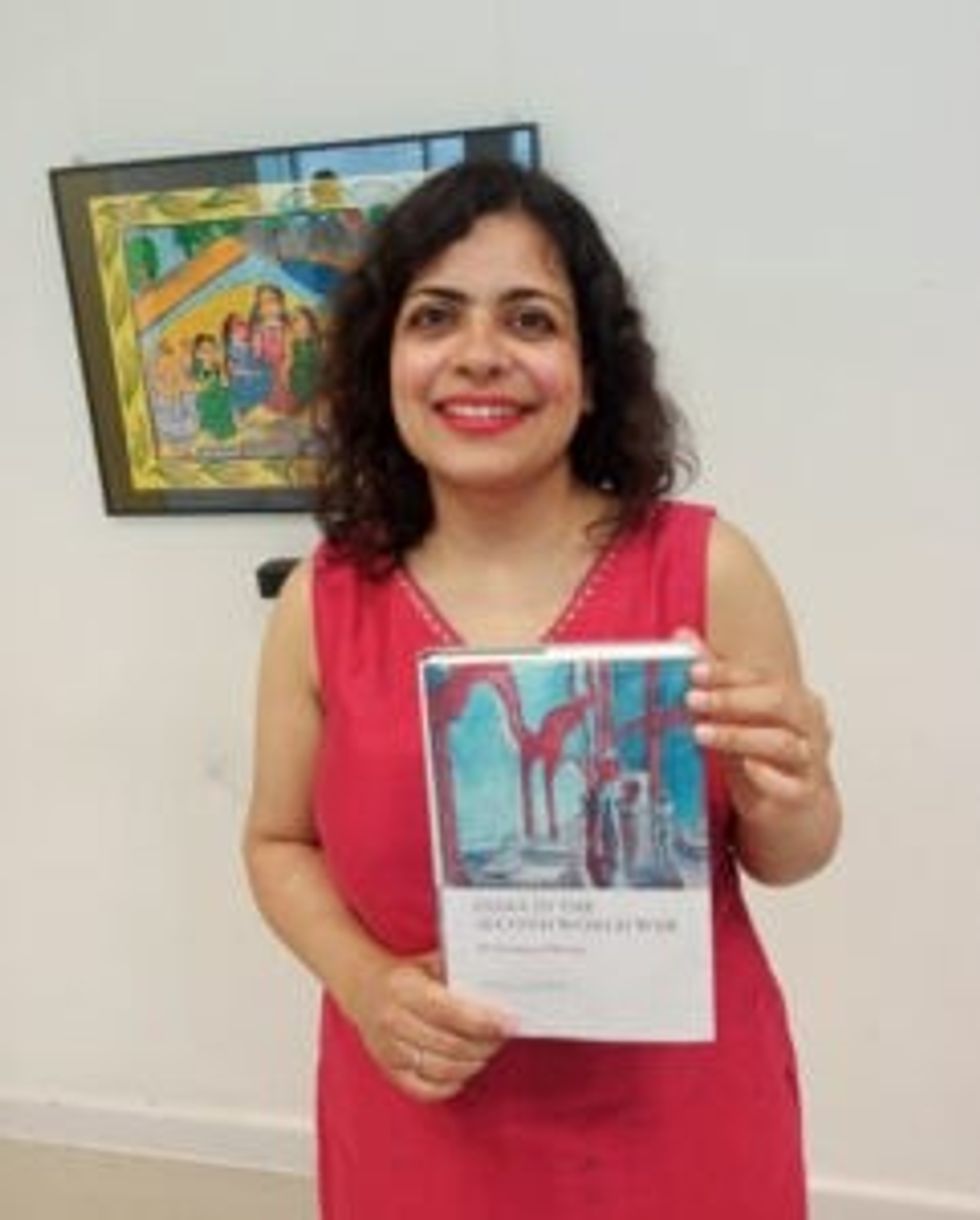 LEAD Inset 2 Hunger Burns. Diya Gupta with her book 27 May 2024 1