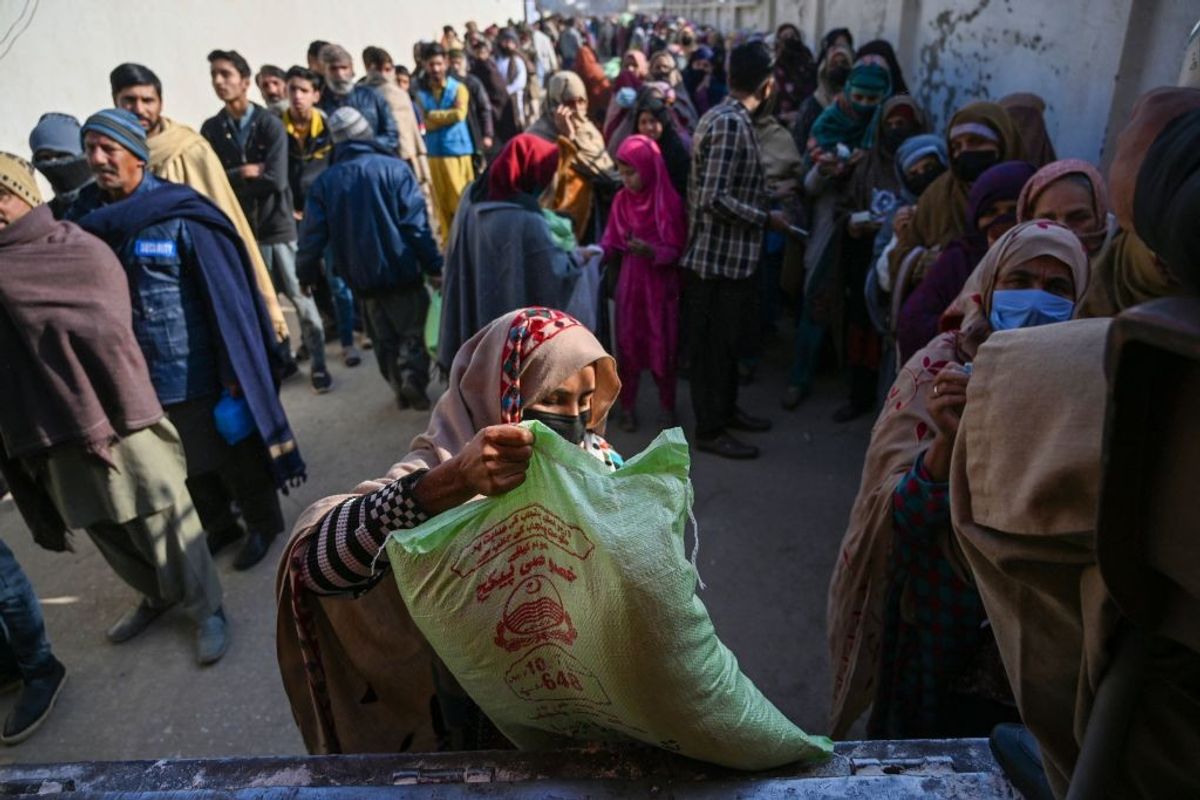 Local residents queue to buy wheat flour at government-controlled prices in Islamabad, Pakistan,