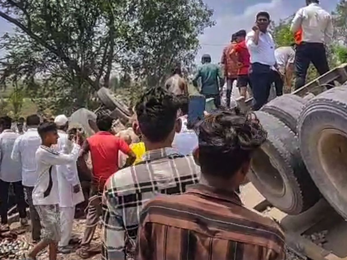 Locals gather at the accident site after a container truck hit four vehicles and then rammed into a hotel on a highway, in Dhule district of the western state of Maharashtra