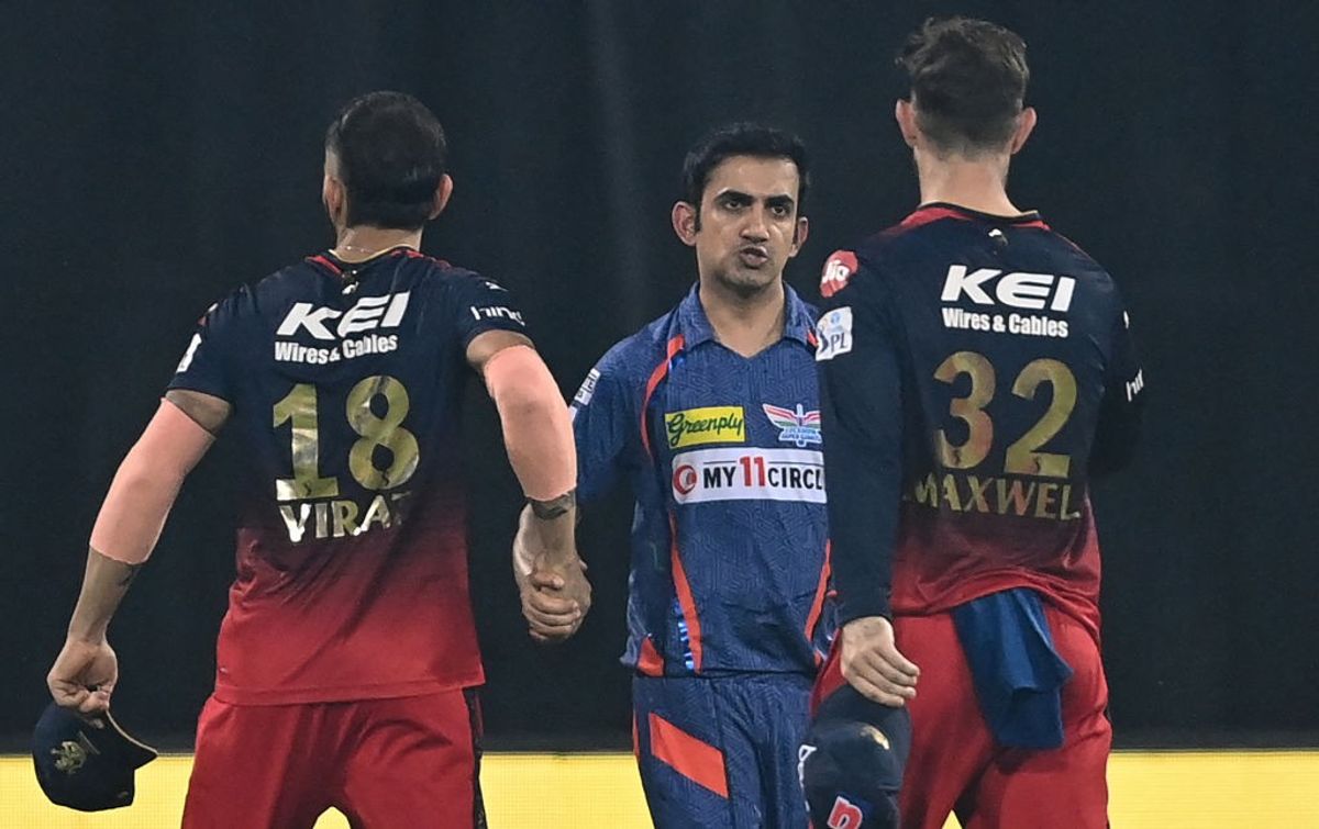 Lucknow Super Giants mentor Gautam Gambhir (C) shakes hands with Royal Challengers Bangalore cricketer Virat Kohli after a game in the IPL 2023