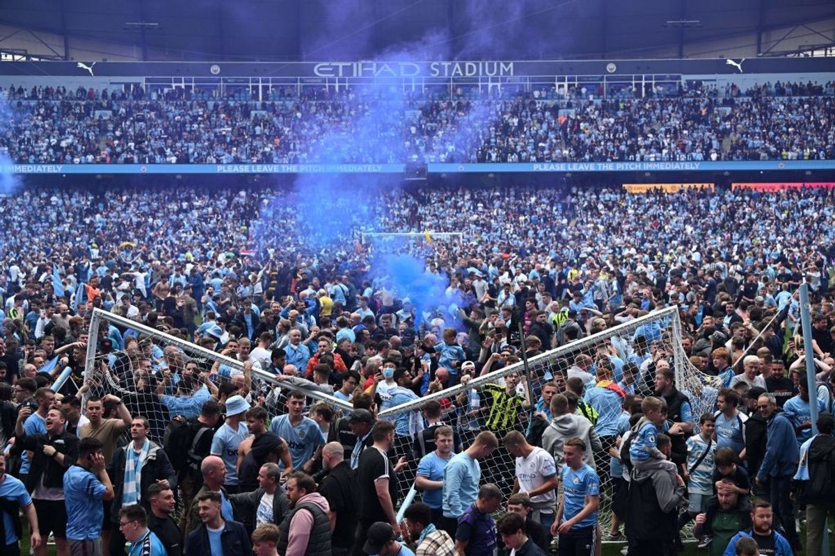 Manchester City fans celebrate after their team won Premier League 2021-22