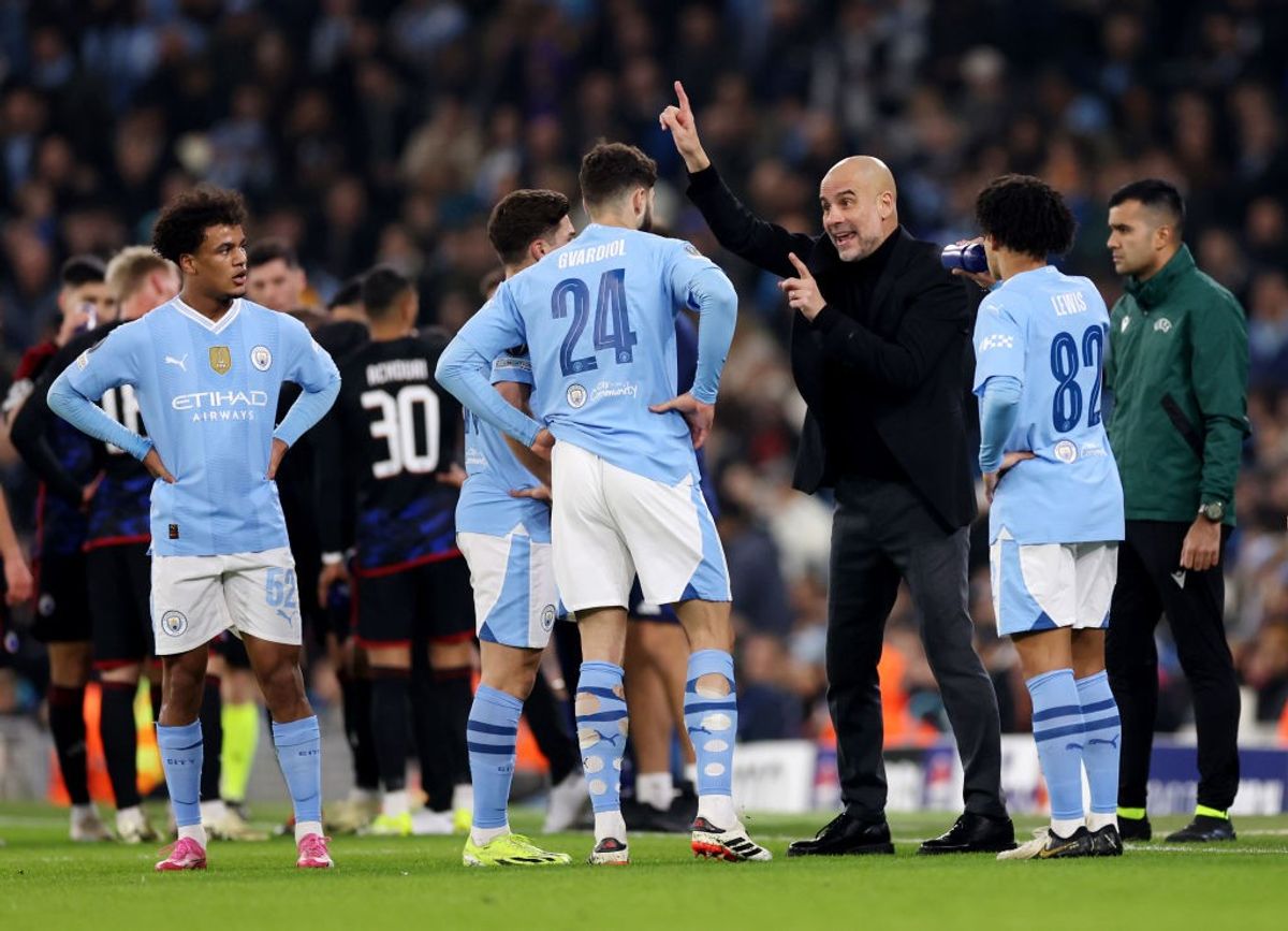 Manchester City manager Pep Guardiola speaks to players