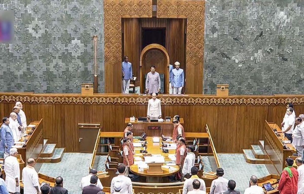 Members of India's newly elected Lok Sabha or Lower House of parliament stand for the national anthem on the inaugural session of the House at the new Parliament building, in New Delhi on Monday, June 24, 2024.