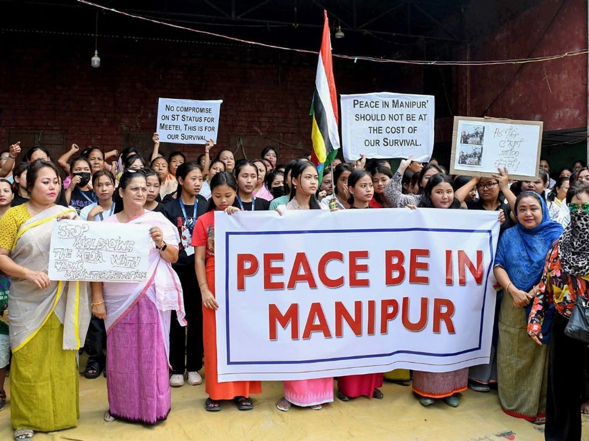 Members of the Manipuri Co-ordination Committee in Guwahati in the northeastsern state of Assam take part in a protest against the clash that broke out in Manipur and appeal to people to maintain peace and harmony in the state, at Manipuri Rajbari, in Guwahati