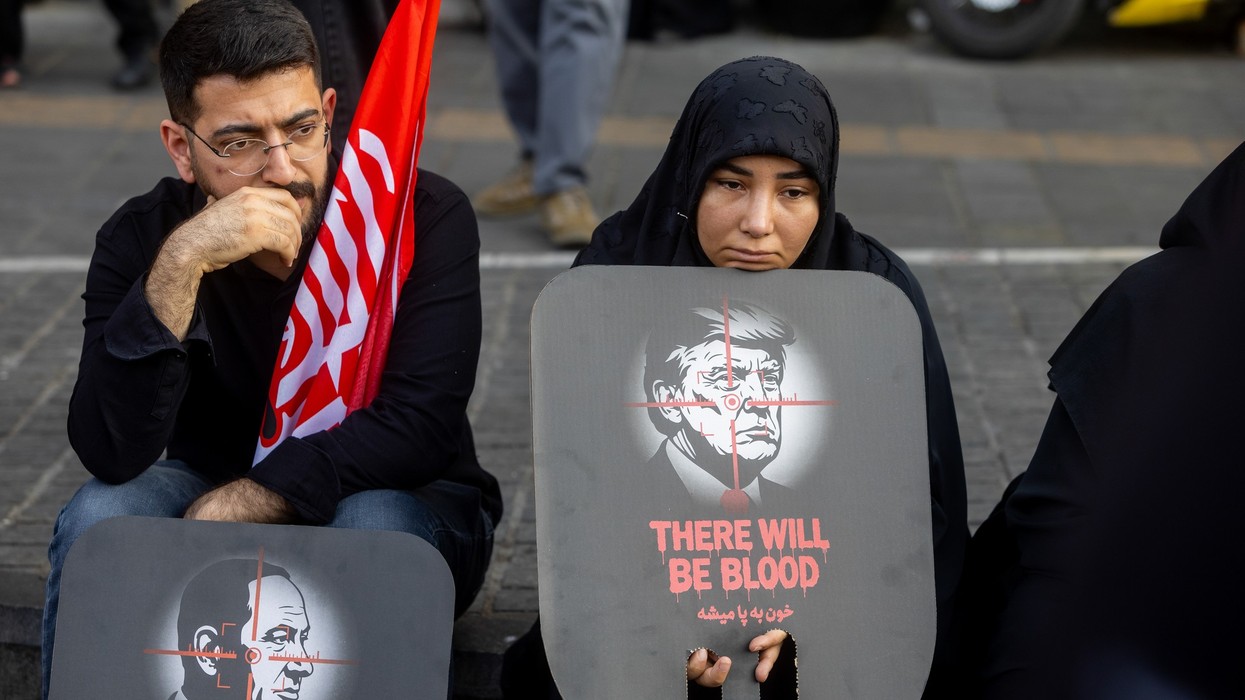 Mourners display anti-Netanyahu and anti-Trump posters
