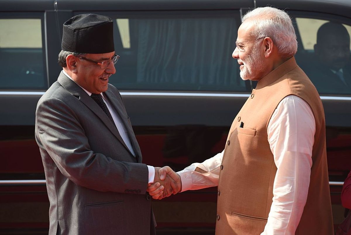 Nepali prime minister Prachanda (L) shakes hands with his Indian counterpart Narendra Modi