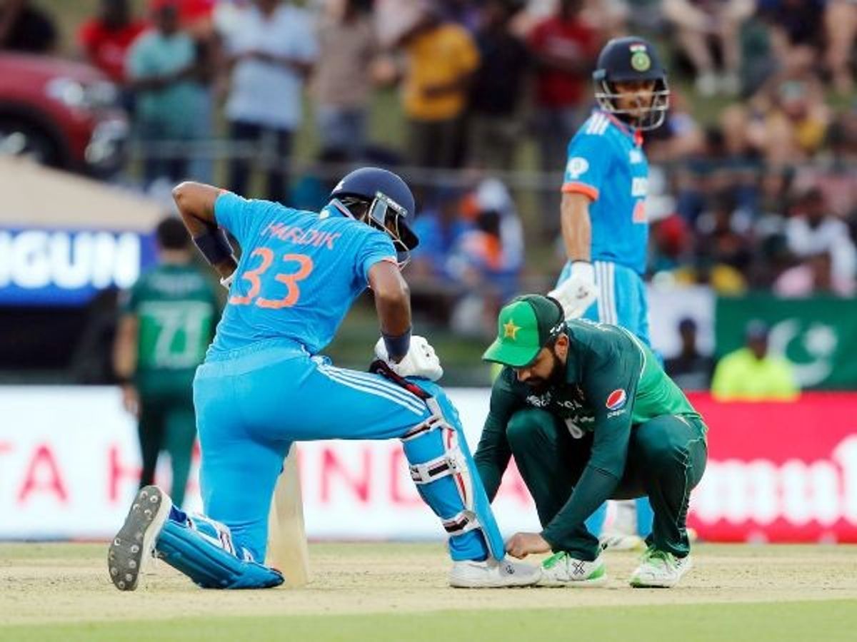 Pakistan cricketer Shadab Khan (in green) ties India batter Hardik Pandya's shoelaces during their match in the Asia Cup 2023, at Pallekele International Cricket Stadium, in Kandy, Sri Lanka