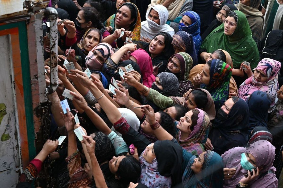 Pakistani women stand in queue for free flour during Ramadan