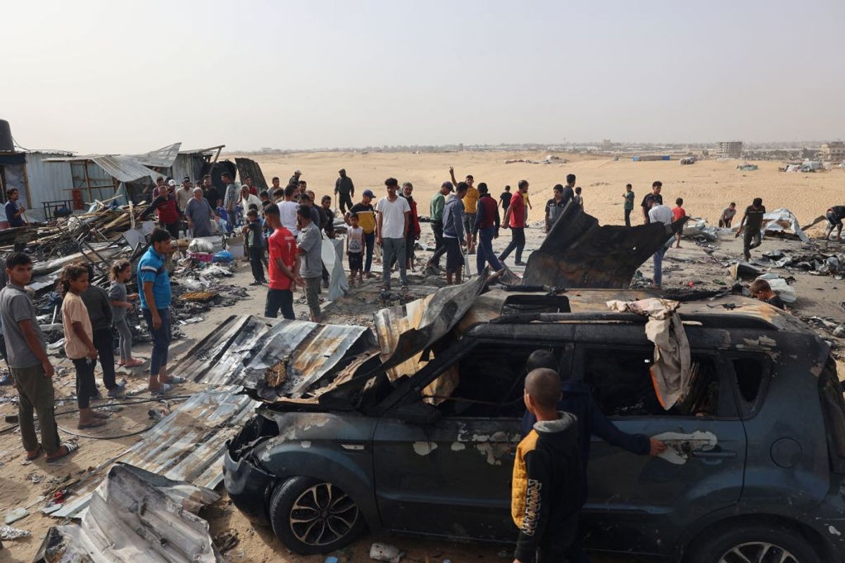 Palestinians gather at the site of an Israeli strike on a camp for internally displaced people in Rafah on May 27, 2024, amid ongoing battles between Israel and the Palestinian Hamas militant group.