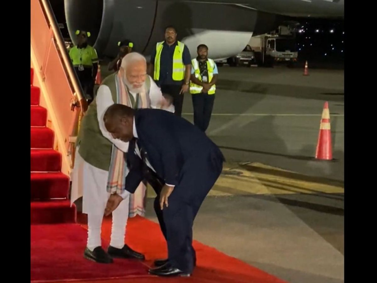 Papua New Guinean prime minister James Marape touches his Indian counterpart Narendra Modi's feet after the latter reached Port Moresby on May 20, 2023