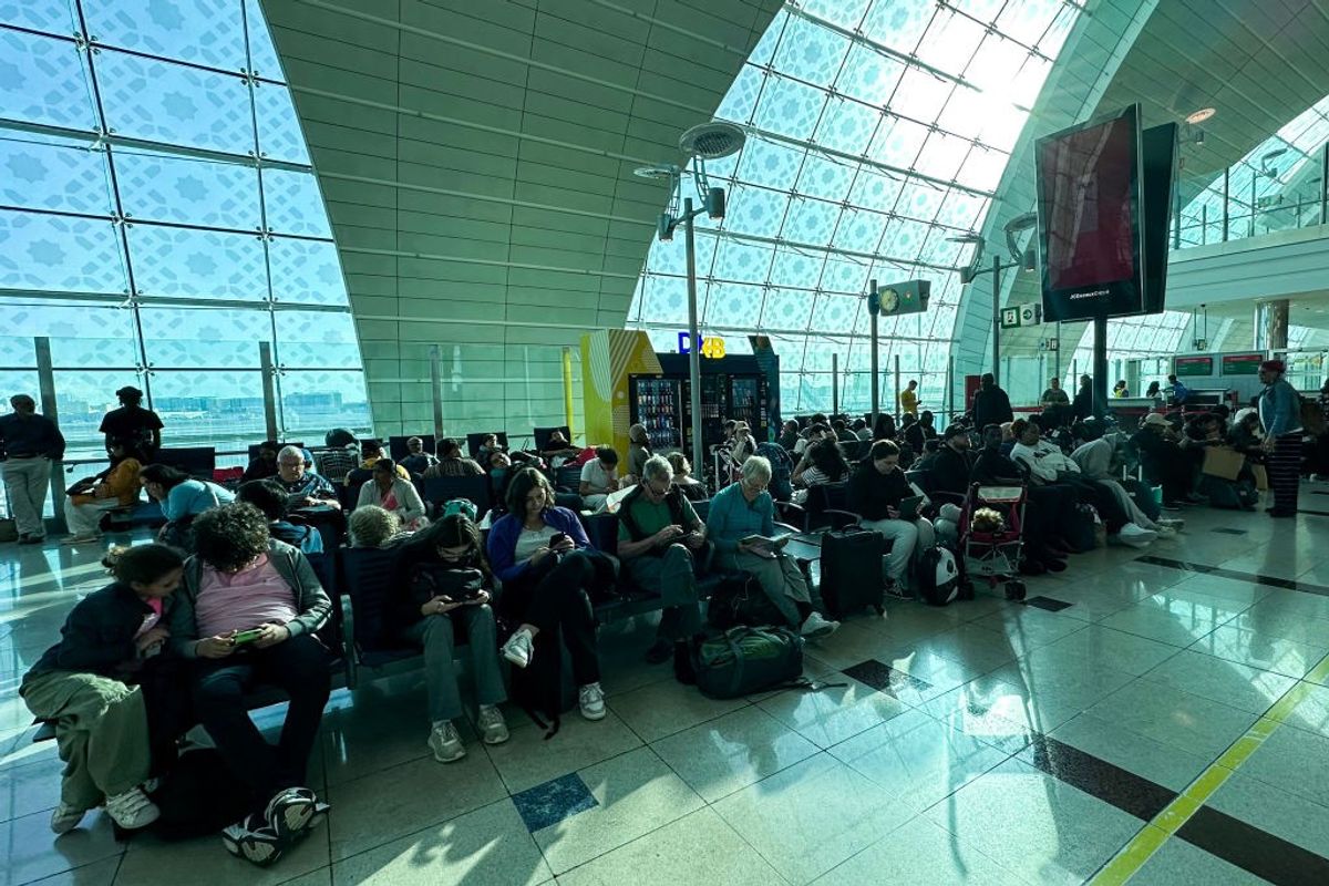 Passengers wait for their flight after operations were hit by heavy rain at Dubai airport in UAE