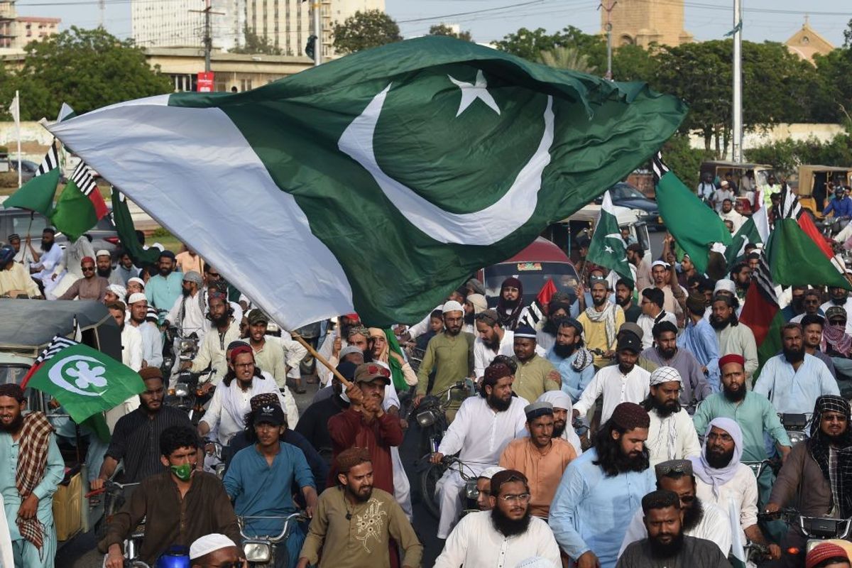 People carrying flags of Pakistan take part in a rally to show solidarity with the country's army
