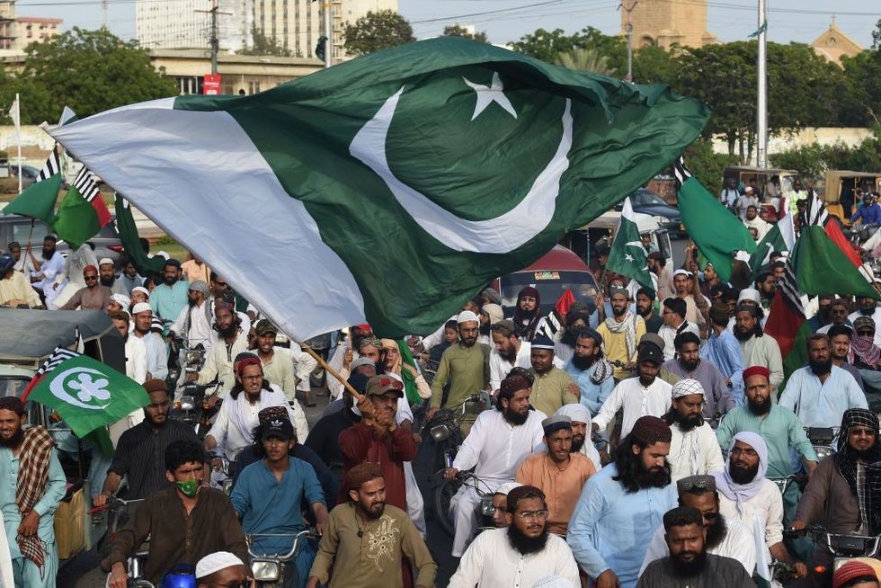 People carrying flags of Pakistan take part in a rally to show solidarity with the country's army