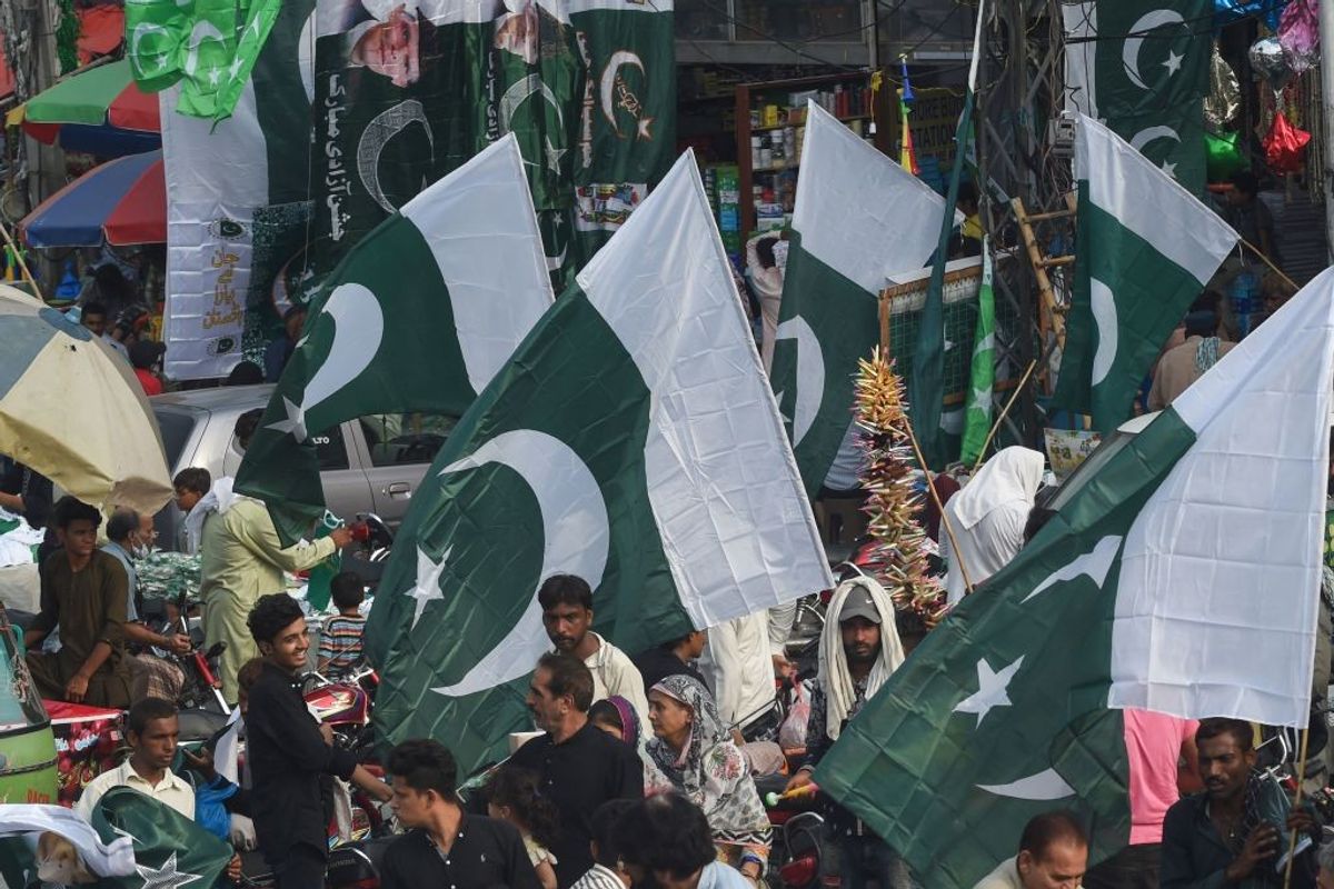 People in Pakistan buy the country's national flag