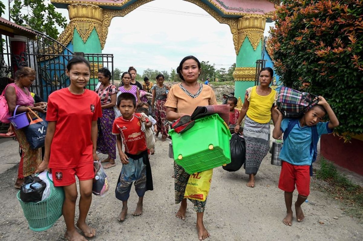 People rush to take shelter in Sittwe town in Myanmar ahead of the expected landfall of Cyclone Mocha