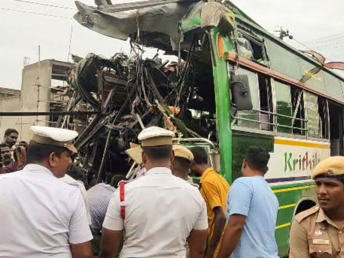 Police personnel inspect the incident site where two private buses collided with each other at Melpattampakkam area, in Cuddalore in the southern Indian state of Tamil Nadu
