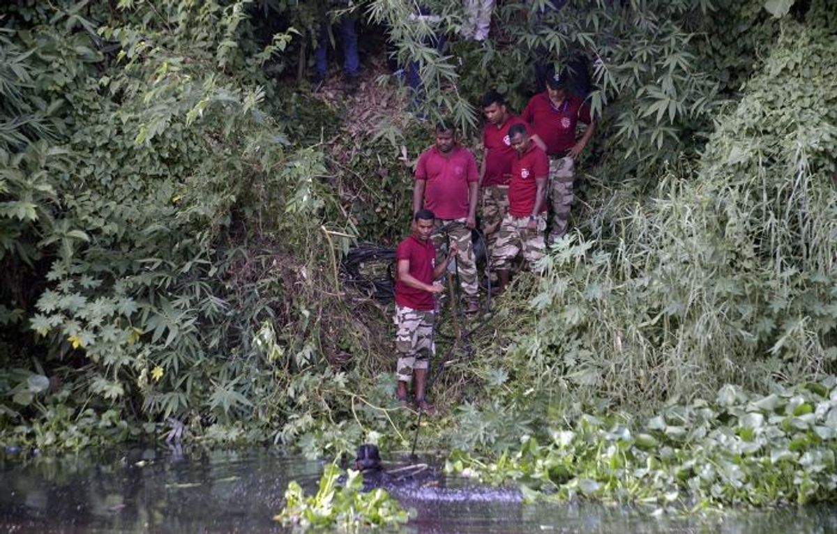 Police personnel search for the body parts of Bangladesh MP Anwarul Azim Anwar who was brutally murdered in the eastern Indian city of Kolkata where he had gone for a medical visit