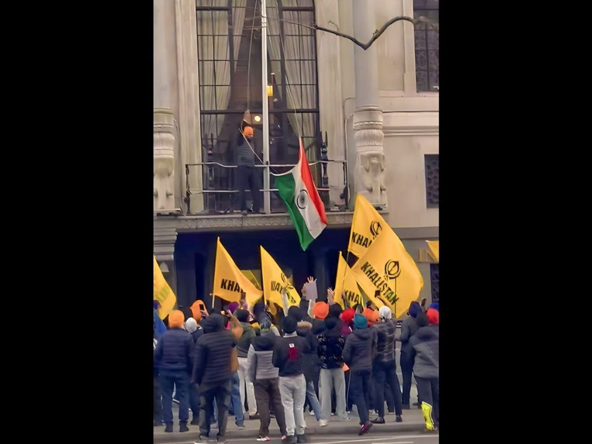 Pro-Khalistan protesters attempt to pull down the Indian national flag at the Indian high commission in London