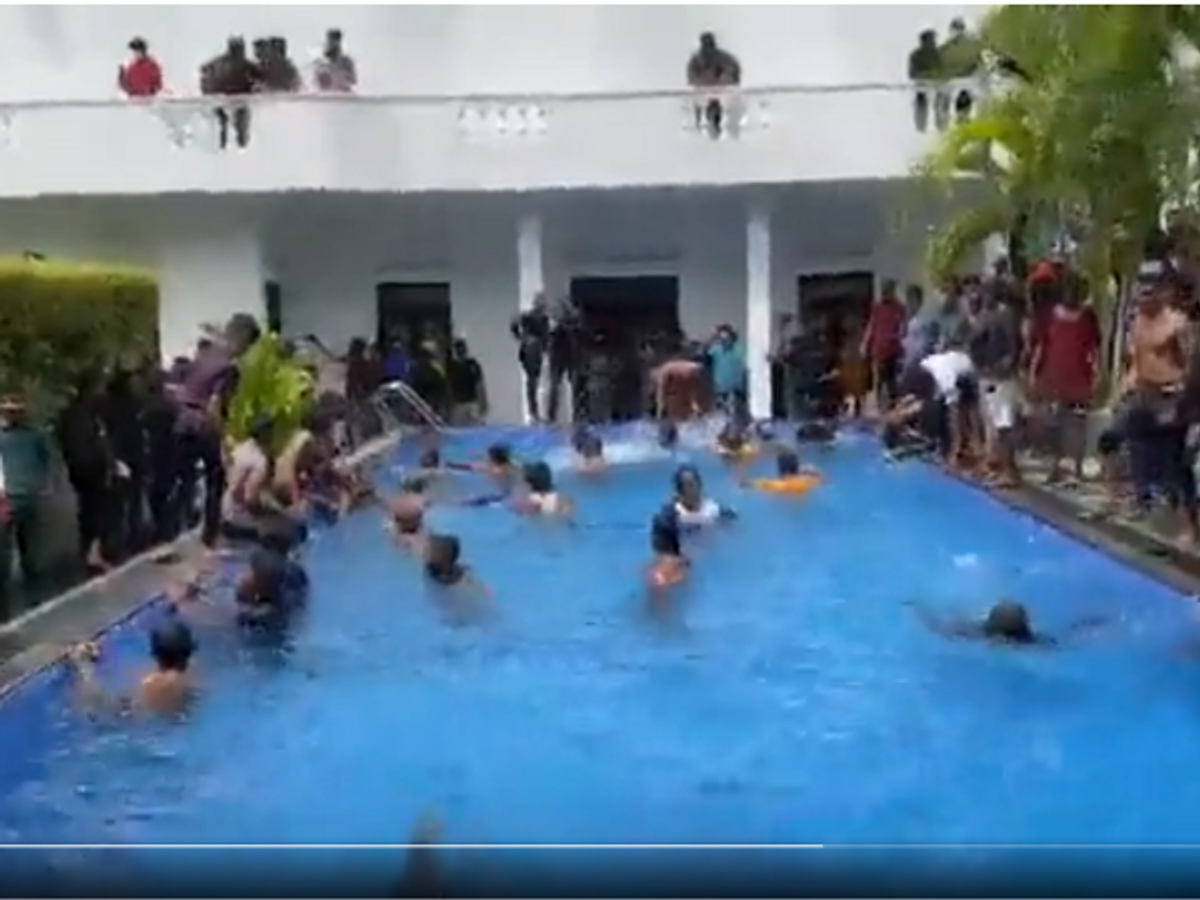 Protesters swim in the pool of Sri Lankan president Gotabaya Rajapaksa's official residence after entering the premises