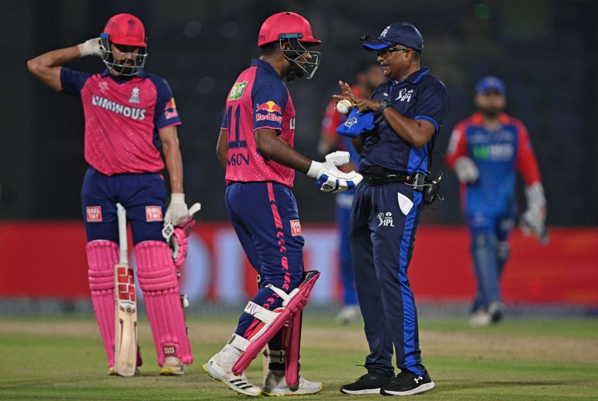 Rajasthan Royals' captain Sanju Samson speaks with the umpire during an IPL 2024 match against Delhi Capitals