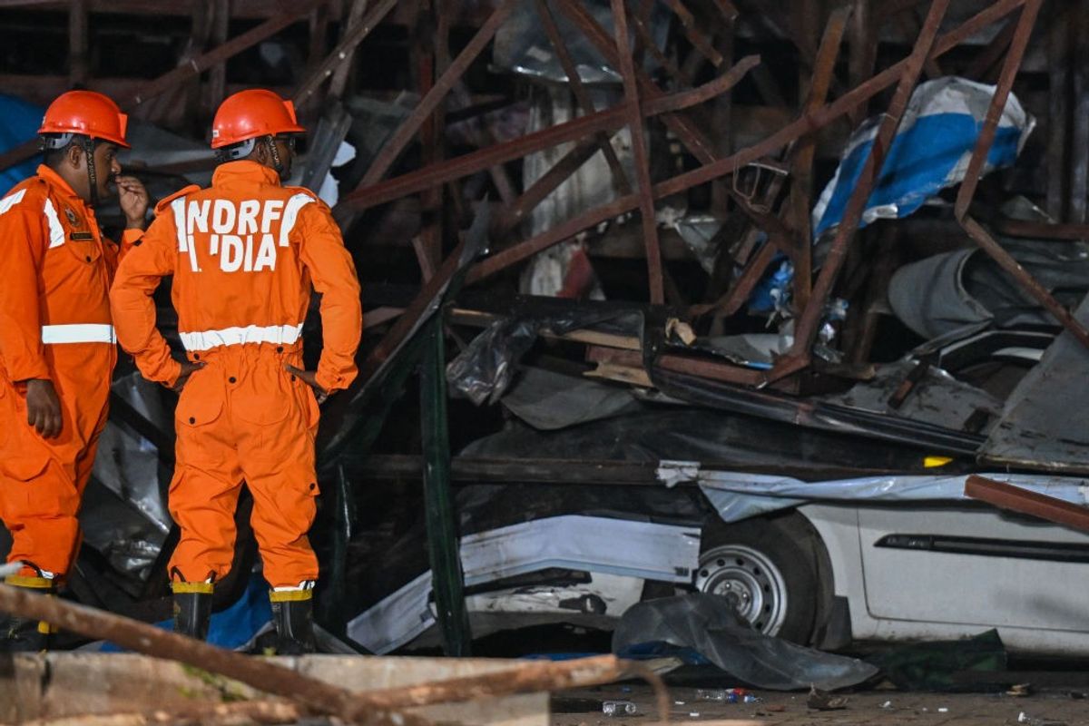 Rescue personnel at the site where a giant hoarding fell on a fuel centre in Mumbai, India, killing 14 people on May 13, 2024.