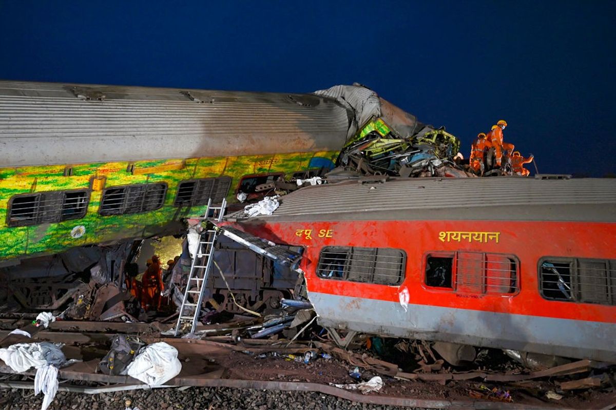 Rescue workers recover victims' bodies from the carriage wreckage of a three-train collision near Balasore, in India's eastern state of Odisha