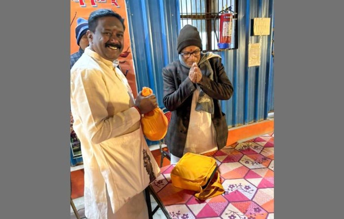 Save Sharda Committee Kashmir member Manjunath Sharma (L) carries holy water from Sharda Peeth in Pakistan Occupied Kashmir to donate to Ram temple ahead of its consecration ceremony in Ayodhya in India's Uttar Pradesh state