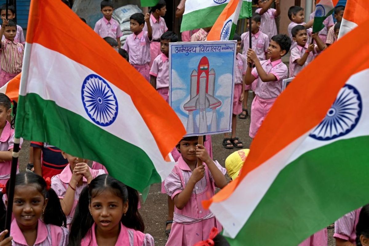 Students wave India's national flag as they gather in support of the Chandrayaan-3 spacecraft in Mumbai, India.