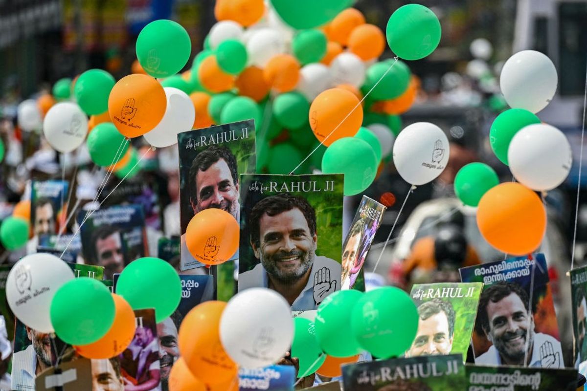 Supporters of Indian National Congress party hold placards featuring their leader Rahul Gandhi during a roadshow in Wayanad, the constituency that he represents