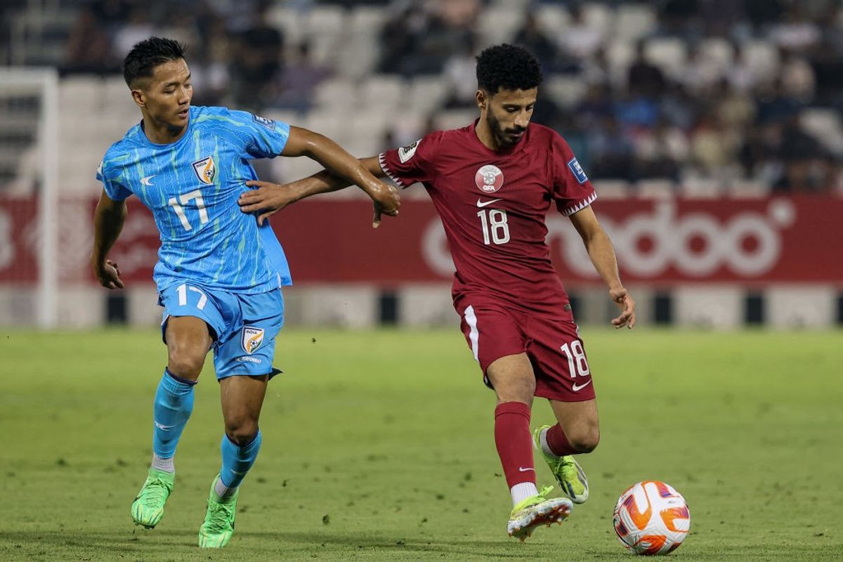 Two India and Qatar footballers vie for the ball during the FIFA World Cup 2026 qualifying match in Doha.