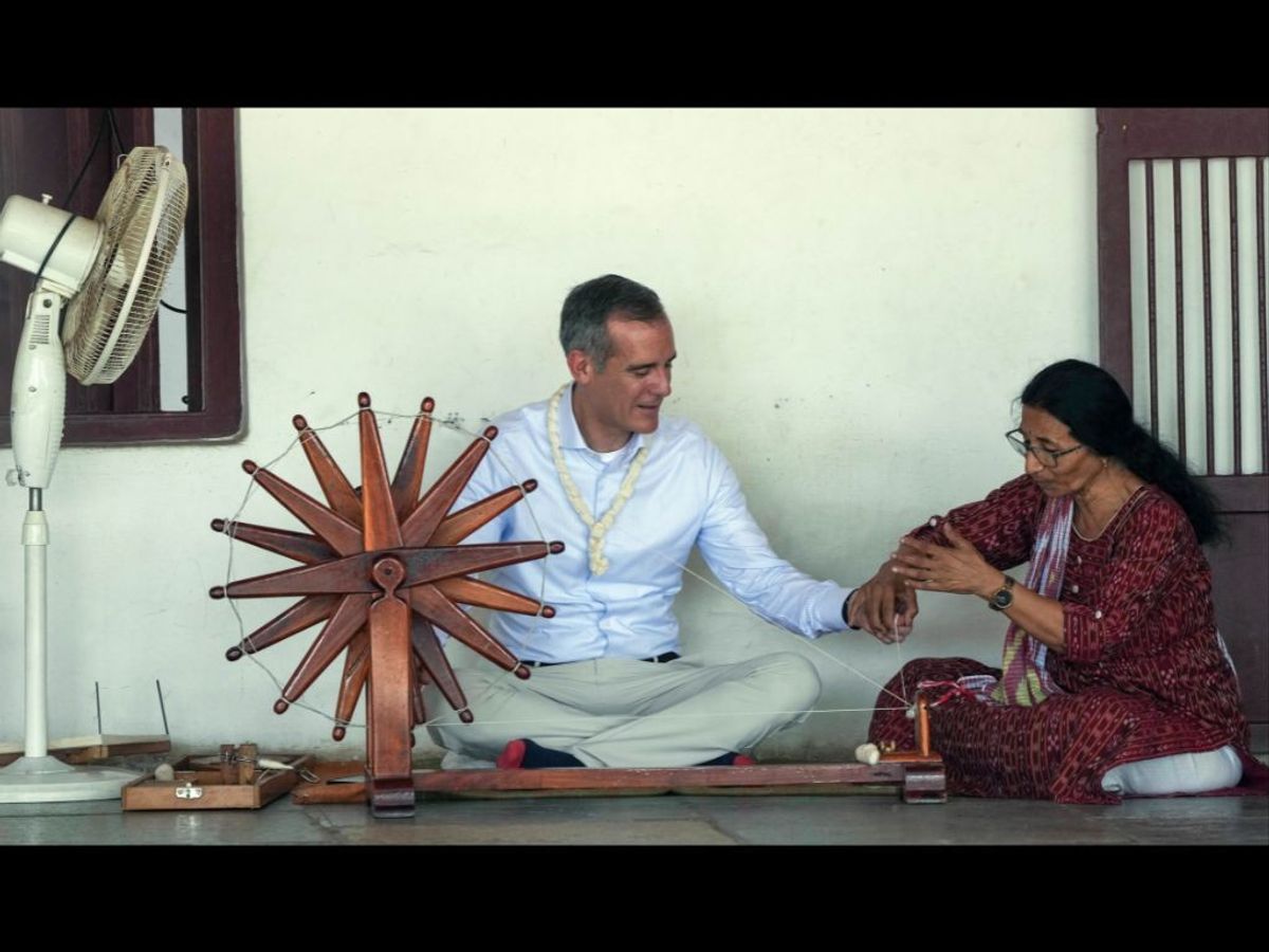 US ambassador to India Eric Garcetti tries his hands on 'Charkha' spinning wheel at Sabarmati Gandhi Ashram in Ahmedabad in India's Gujarat state