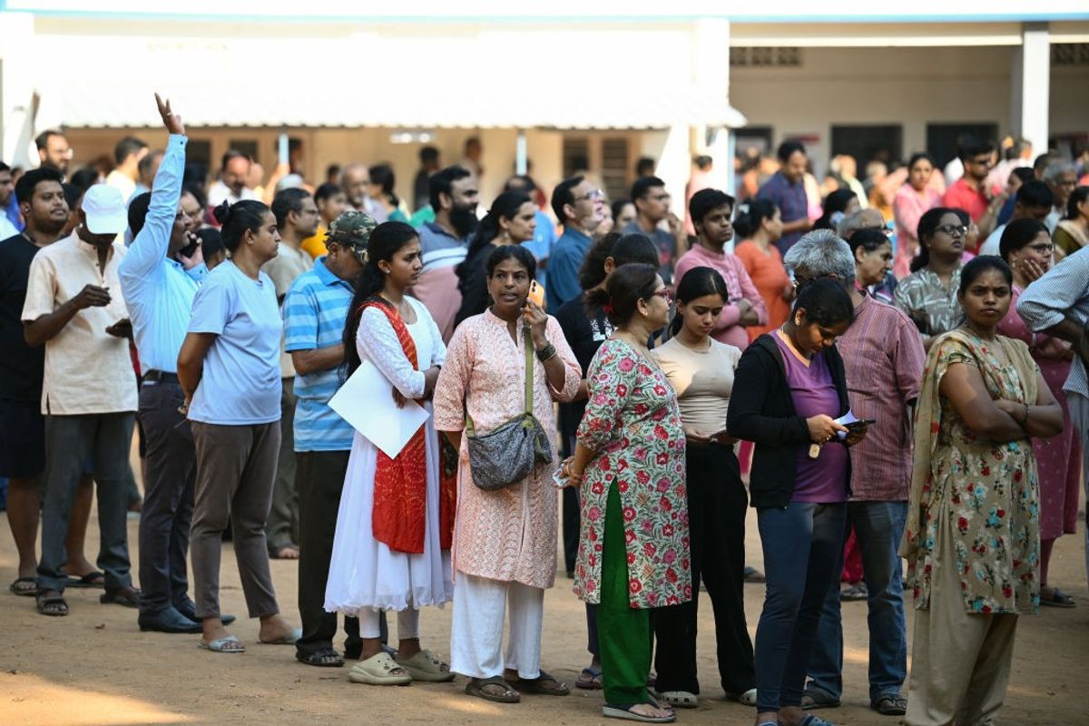 Voters queue up to cast their ballot outside a polling station during the second phase of voting of India's general election in Bengaluru in the southern state of Karnataka.