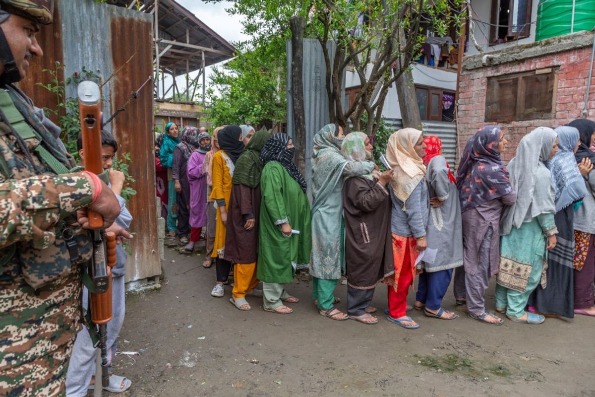 Voters stand in queue to cast ballots in the Indian general elections in the northern Union Territory of Kashmir on May 13, 2024.