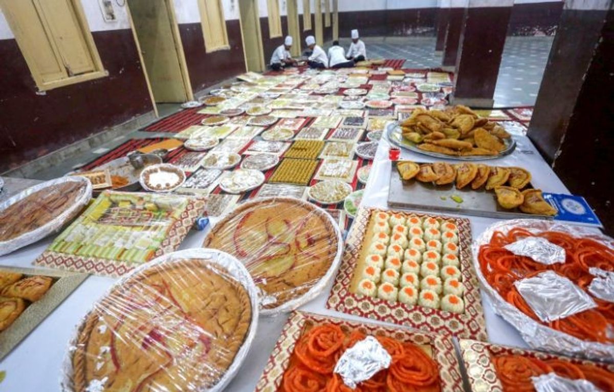Workers pack sweets ahead of the consecration ceremony of Ram Temple, in Bhopal in the central Indian state of Madhya Pradesh